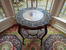 A mahogany occasional table with carved scroll decoration to the top, and lower gallery,