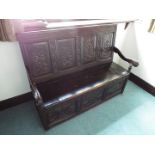 A Victorian superbly carved oak monk's bench,