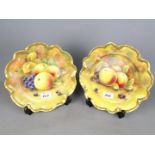 Coalport - two cabinet plates hand painted with fruit, with gadrooned gilded rims,