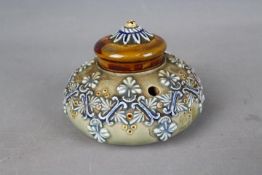 A Doulton Lambeth Stoneware inkwell of squat bulbous form, relief decorated with stylised motifs,