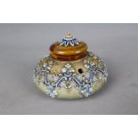 A Doulton Lambeth Stoneware inkwell of squat bulbous form, relief decorated with stylised motifs,