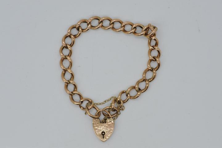 A 9ct rose gold bracelet with padlock clasp and safety chain, stamped 9c, 20 cm (l),