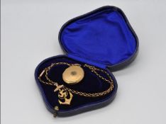 A 9ct gold Front and Back locket on a yellow metal chain (chain A/F) and an Isle of Man brooch