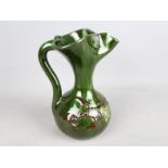 Elton Studio Ware - a jug with floral decoration on a green ground,