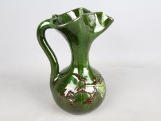 Elton Studio Ware - a jug with floral decoration on a green ground,