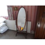 An early 20th century cheval mirror, the oval glass with bevel edge,
