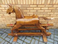 A good quality carved wood rocking horse on gliders,