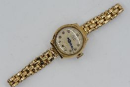 A lady's 9ct gold cased, Leda, 17 jewel wristwatch on rolled gold expanding bracelet,