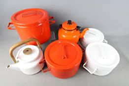 A collection of Finnish enamel ware by Arabia, Finland comprising lidded cooking pots and teapots.