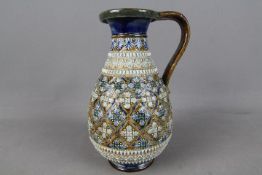 A Doulton stoneware jug with relief decoration, no impressed marks, incised monogram for John Broad,
