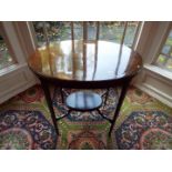 An Edwardian oval top mahogany table with lower gallery,