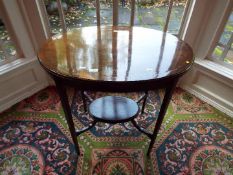 An Edwardian oval top mahogany table with lower gallery,