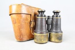 A pair of early 20th century binoculars Ross, London, stamped with Broad Arrow / crows foot,