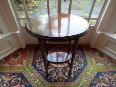 An Edwardian oval top mahogany table with lower gallery,