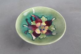 A Moorcroft Pottery small pedestal bowl decorated with columbine on a green ground, 10.