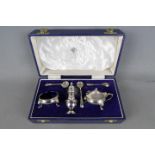 A hallmarked silver condiment set, salt pepper and serving spoons, Sheffield assay 1972,