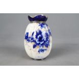 A Doulton Burslem vase of lobed form with blue floral and gilt decoration against a white ground, c.