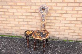 An ornamental Welsh milking stool with floral and foliate decoration and a small heart-shaped stool