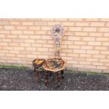 An ornamental Welsh milking stool with floral and foliate decoration and a small heart-shaped stool