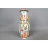 A 19th century Asian twin-handled vase with flared rim, hand painted with images of figures, birds,