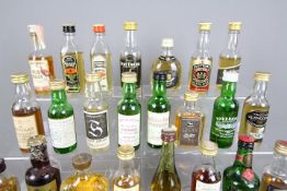 Twenty five whisky / whiskey miniatures, predominantly Scotch, to include Tomatin, Glenlossie,