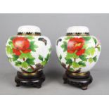 A pair of Chinese cloisonné ginger jars and covers decorated with flowers and butterfly,
