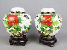 A pair of Chinese cloisonné ginger jars and covers decorated with flowers and butterfly,