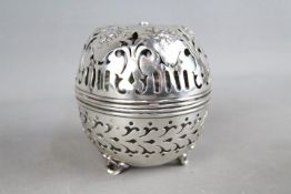 A sterling silver string box of globular form,