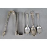 A collection of hallmarked silver items to include Georgian spoons and tongs,