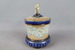 Doulton Lambeth - A late 19th century stoneware tobacco jar and cover of waisted form and relief