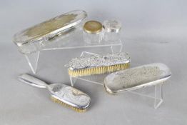 A collection of Swedish plated dressing table items and one silver backed dressing table brush,
