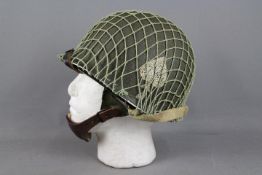 An original WW2 US M1 paratroopers helmet restored by the vendor.