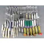 A large quantity of knife rests to include ceramic, plated, pewter, cut glass and similar.