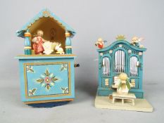 Two Erzgebirge hand painted wooden music boxes.