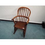 A child's oak rocking chair,