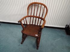 A child's oak rocking chair,