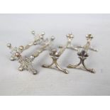 Two pairs of hallmarked silver knife rests comprising a Victorian pair,