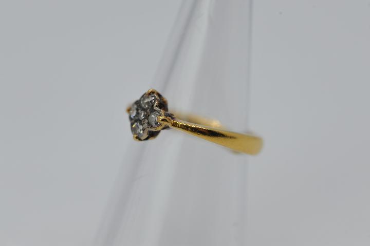 A 22ct gold ring set with a cluster of diamonds, size L, approximately 4 grams all in. - Image 2 of 4