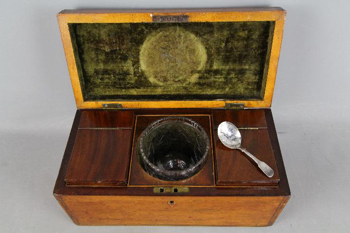 An early 19th century tea caddy, the interior fitted with two subsidiary caddies and mixing bowl,