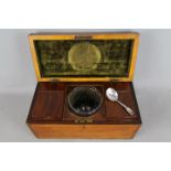 An early 19th century tea caddy, the interior fitted with two subsidiary caddies and mixing bowl,