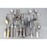 A collection of silver and white metal items to include three silver thimbles, silver sugar spoon,