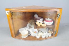 A display case containing a quantity of miniature tea wares