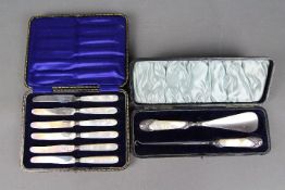 A Victorian shoe horn and button hook set, the Mother of Pearl grips with hallmarked silver mounts,