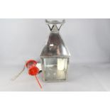 A large chrome candle lantern, approximately 68 cm (h) including handle and a Lars garden lantern.