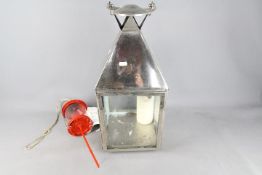 A large chrome candle lantern, approximately 68 cm (h) including handle and a Lars garden lantern.