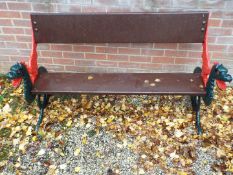 A garden bench seat with wooden planked back and seat,