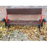 A garden bench seat with wooden planked back and seat,