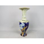 A large Royal Doulton stoneware vase with elongated neck and flared rim,