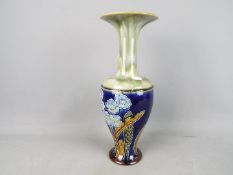 A large Royal Doulton stoneware vase with elongated neck and flared rim,