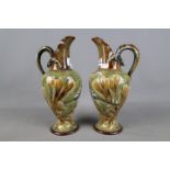 Doulton Lambeth - A set of two Frank Butler stoneware ewers decorated with an underwater scene and